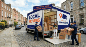 Local Movers truck in Dublin street, movers loading boxes labeled "Kitchen," "Living Room," and "Bedroom." Signage reads "Local Movers" and "Guide by Local Movers: Moving from Dublin to Galway.
